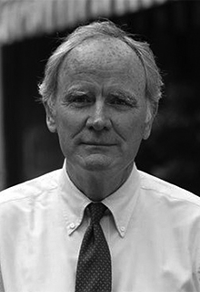  A black and white image of a white man in a suit and tie